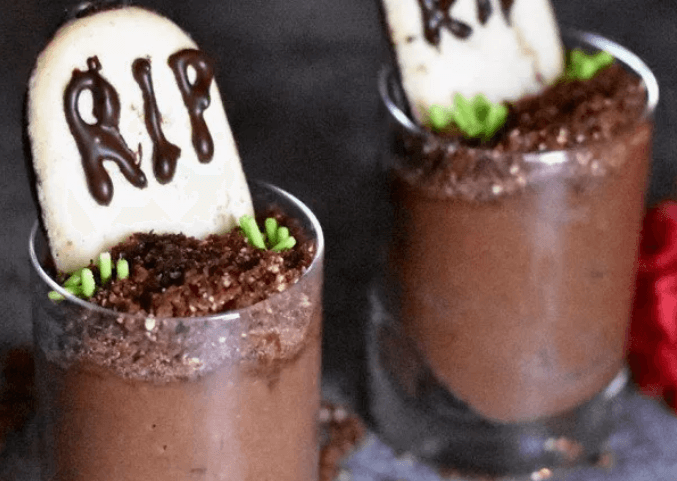 Two chocolate mousse with cookies in them.