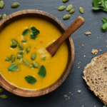 Curried coconut butternut squash soup in a wooden bowl.