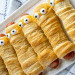 hot dogs wrapped in crescent rolls with eyes to resemble mummys.