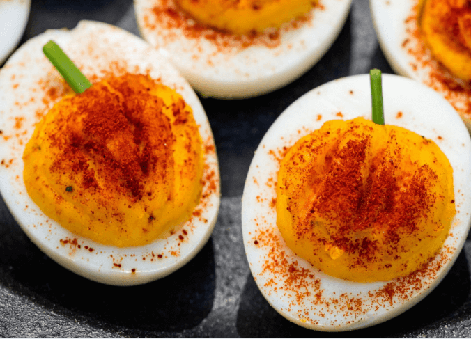 Deviled eggs with yolks that resemble pumpkins.