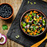 Roasted Sweet Potato Salad with bowl of black beans next to it.