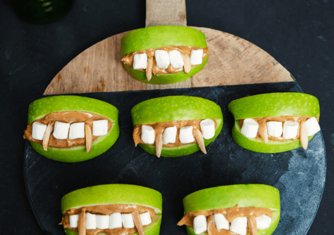 Nut butter and marshmallows in between two apple slices.