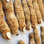 Sugar cookies with sliced almonds on them.