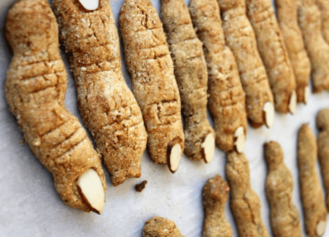 Sugar cookies with sliced almonds on them.