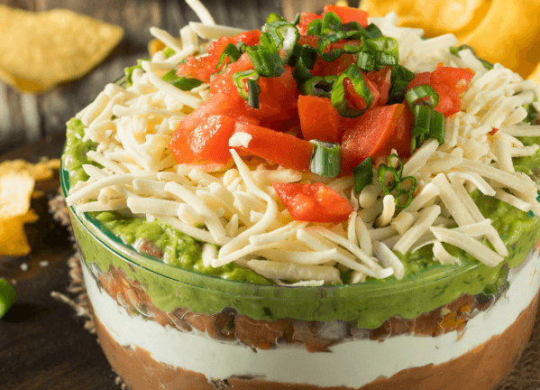 Tomatoes, cheese, guacamole, beans, sour cream layered dip.