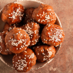 Teriyaki Meatballs in a small bowl topped with sesame seeds