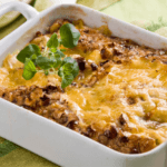 Baked lentil casserole in a white dish.