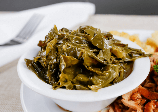 Collard greens in a white bowl.