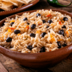 Rice, black beans, and tomatoes in a bowl.
