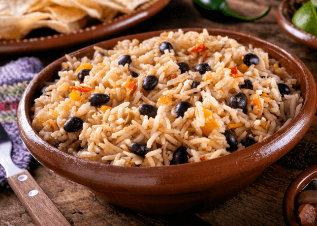 Rice, black beans, and tomatoes in a bowl.