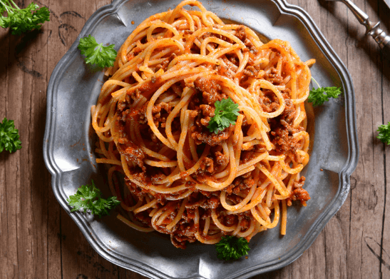 Plate with spaghetti noodles and pasta sauce.