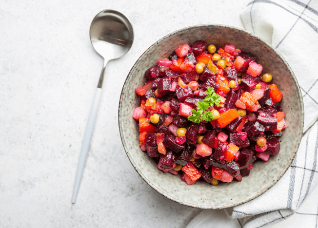 Pink beets, pea salad with a spoon.