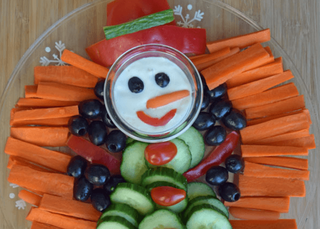 Carrots, black olives, cucumber, tomatoes, and dip.