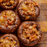 Stuffed mushrooms on a wood board.