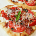Naan bread margherita pizza with tomatoes and cheese.