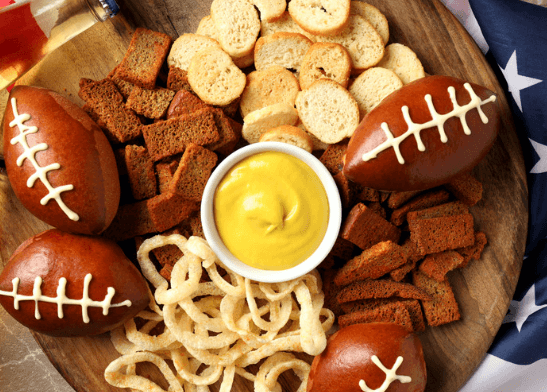 Food balls, crackers, pita chips all on a platter.