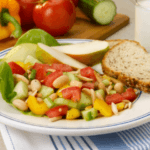 Cannellini beans, tomato, cucumber, apple salad with bread.