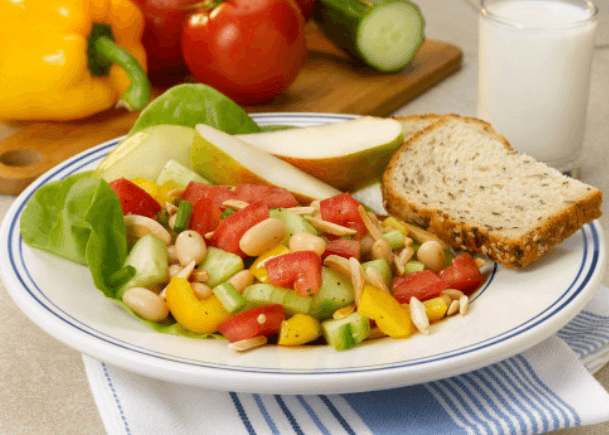 Cannellini beans, tomato, cucumber, apple salad with bread.