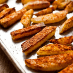 Kohlrabi fries on a baking sheet.