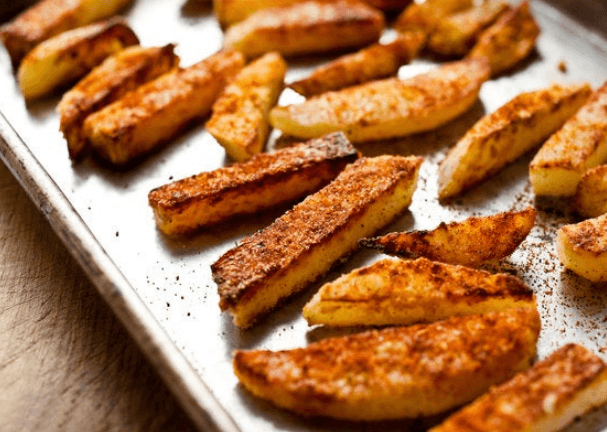 Kohlrabi fries on a baking sheet.