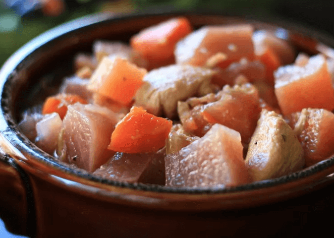 Diced chicken, rutabaga, and beets stew in a bowl.