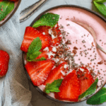 Strawberry smoothie bowl with strawberries in it.