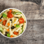 Pasta salad with carrots, broccoli, and peppers.
