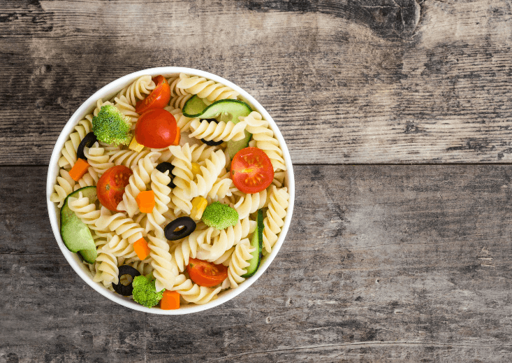 Pasta salad with carrots, broccoli, and peppers.