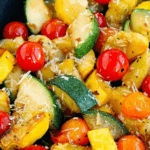 A bowl of sautéed squash and cherry tomatoes