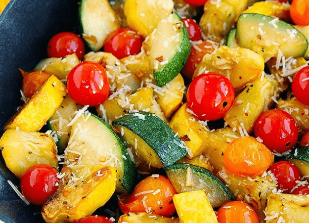 A bowl of sautéed squash and cherry tomatoes