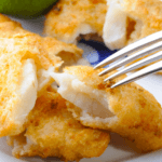 A closeup photo of baked fish and chips
