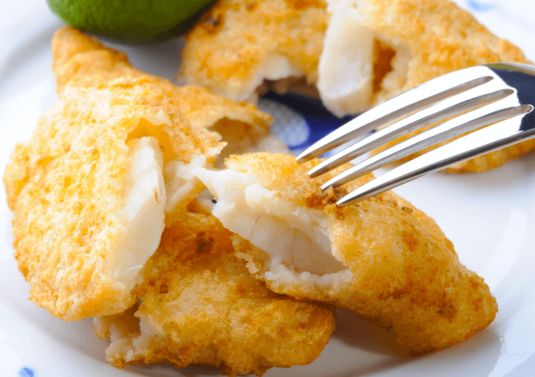 A closeup photo of baked fish and chips