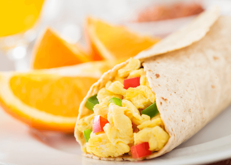 A closeup photo of a breakfast burrito with egg and red and green peppers