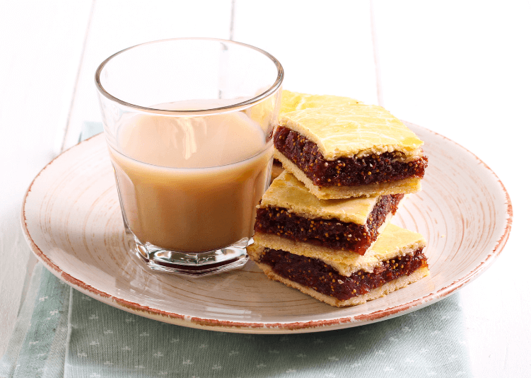 A plate of fig bars and a glass of tea