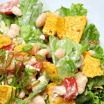 A closeup of a taco salad on a white background