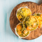 Four muffins on a serving board