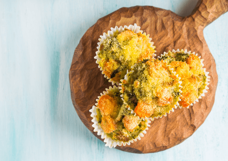 Four muffins on a serving board