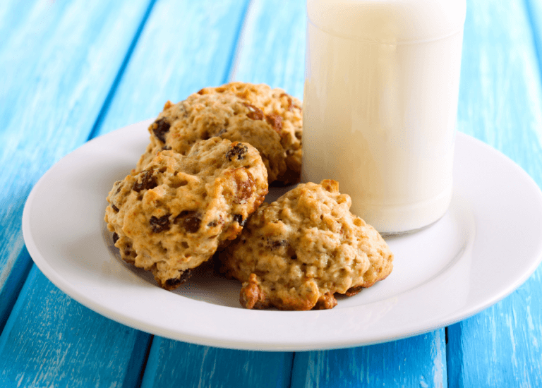 Applesauce cookies with raisins and a glass of milk.