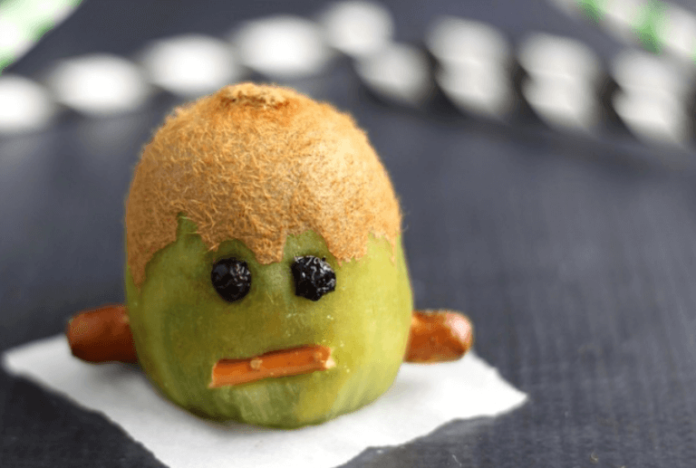 Kiwi with raisin eyes and pretzel mouth.