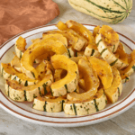 Sliced butternut squash slices on a plate.