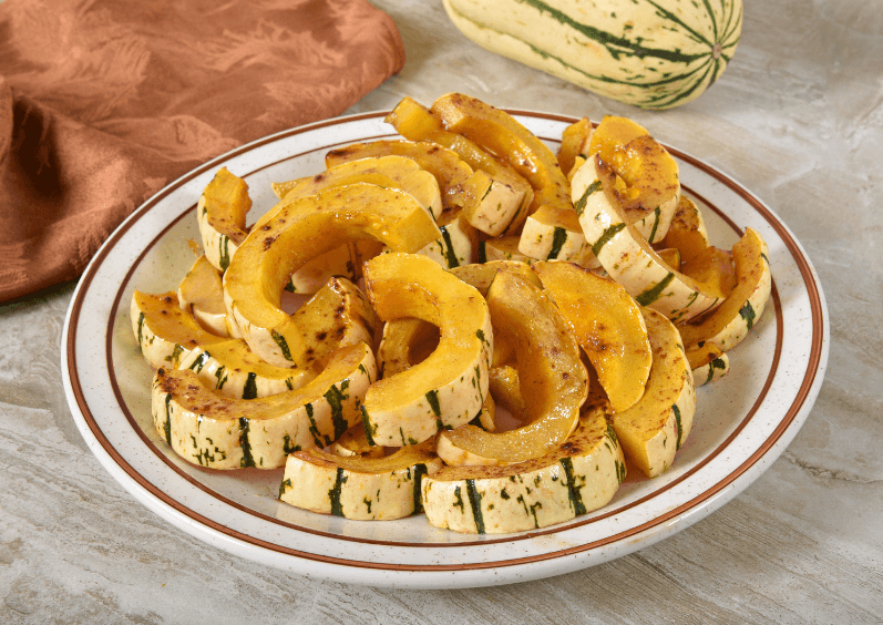 Sliced butternut squash slices on a plate.