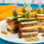 Mini sandwich skewers on a plate.