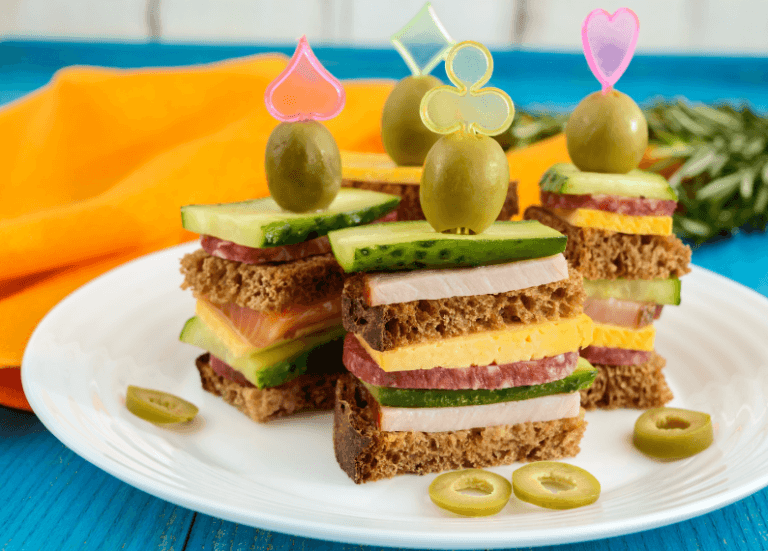 Mini sandwich skewers on a plate.