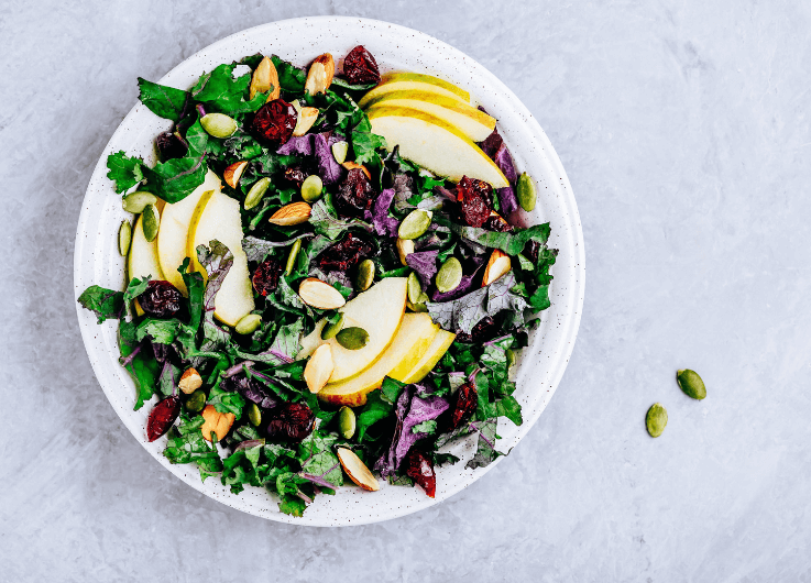 apples, greens, and nuts in a salad