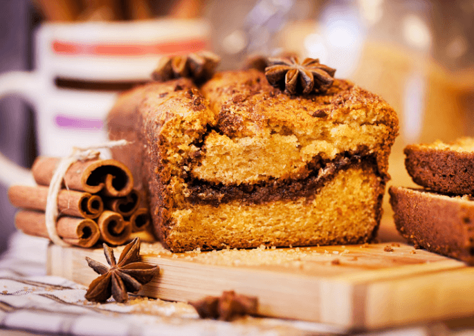 loaf of applesauce cake with cinnamon sticks