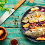 Baked trout on a plate with a knife