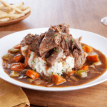 Beef pot roast on mashed potatoes with carrots