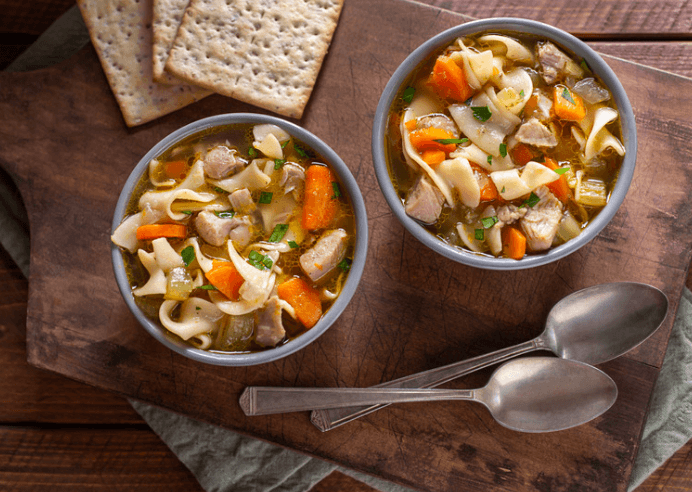 Two bowls of chicken noodle soup