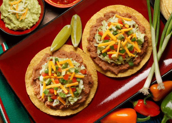 turkey tostadas with green onions, tomatoes, shredded cheese