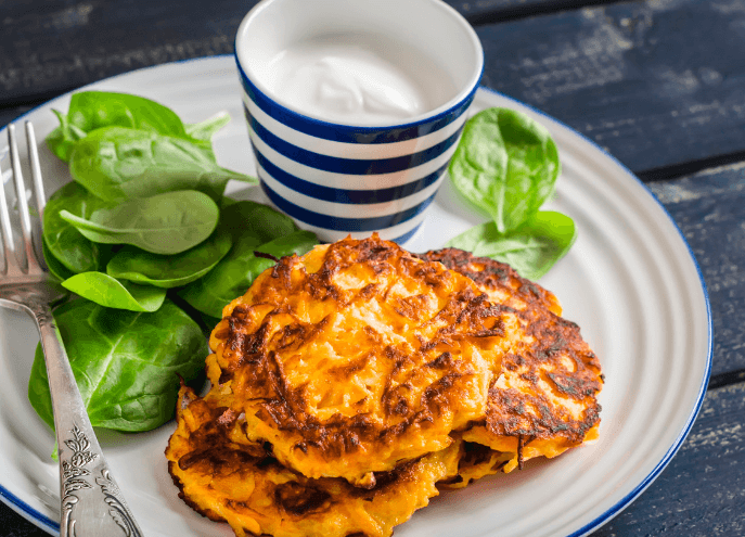 spinach and potato pancakes with baby spinach and glass of milk